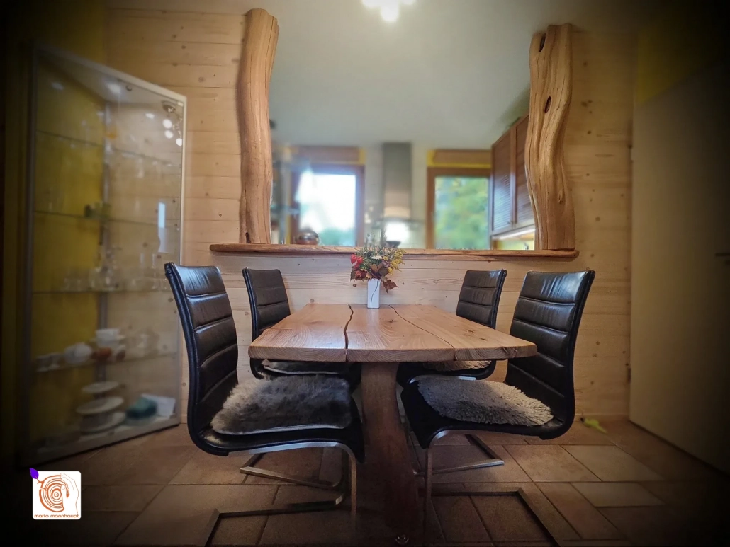 Wohnraumdesign mit einem Esstisch und Wandeinfassung in Naturform aus Hartholz